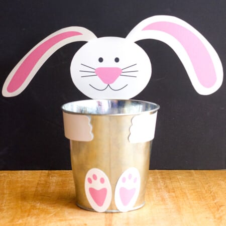 a metal cup with a paper bunny printable around it