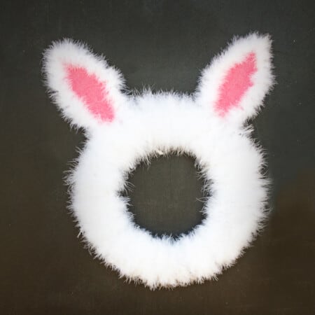 a white Easter Bunny Wreath with pink ears.